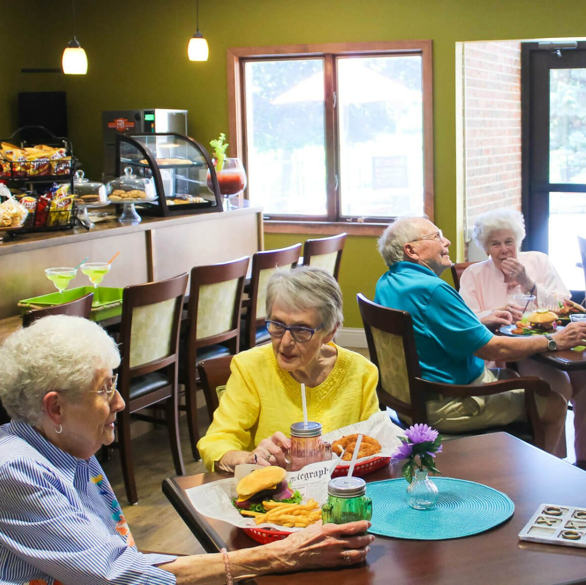 Group of independent retirees socializing in the Cold Creek Café and eating lunch