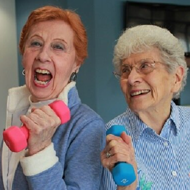 Retired ladies lifting weights during their wellness class
