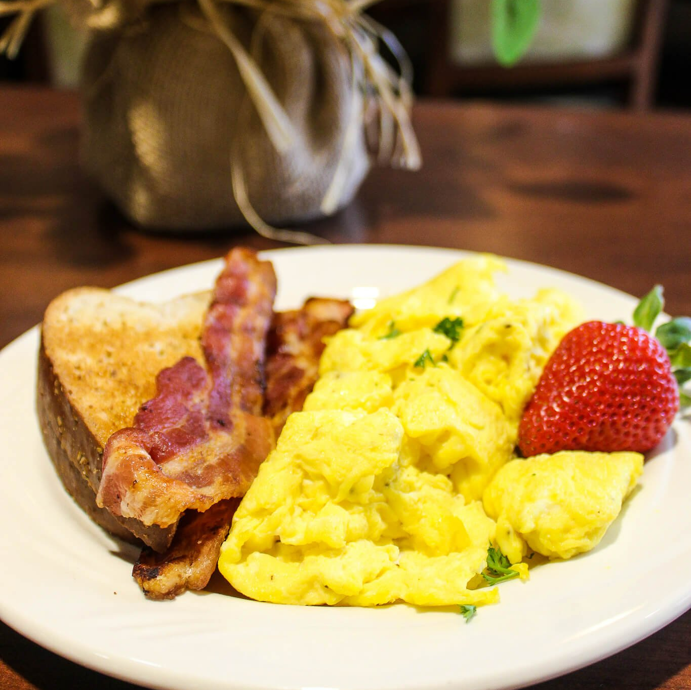 plate of bacon, scrambled eggs and toast