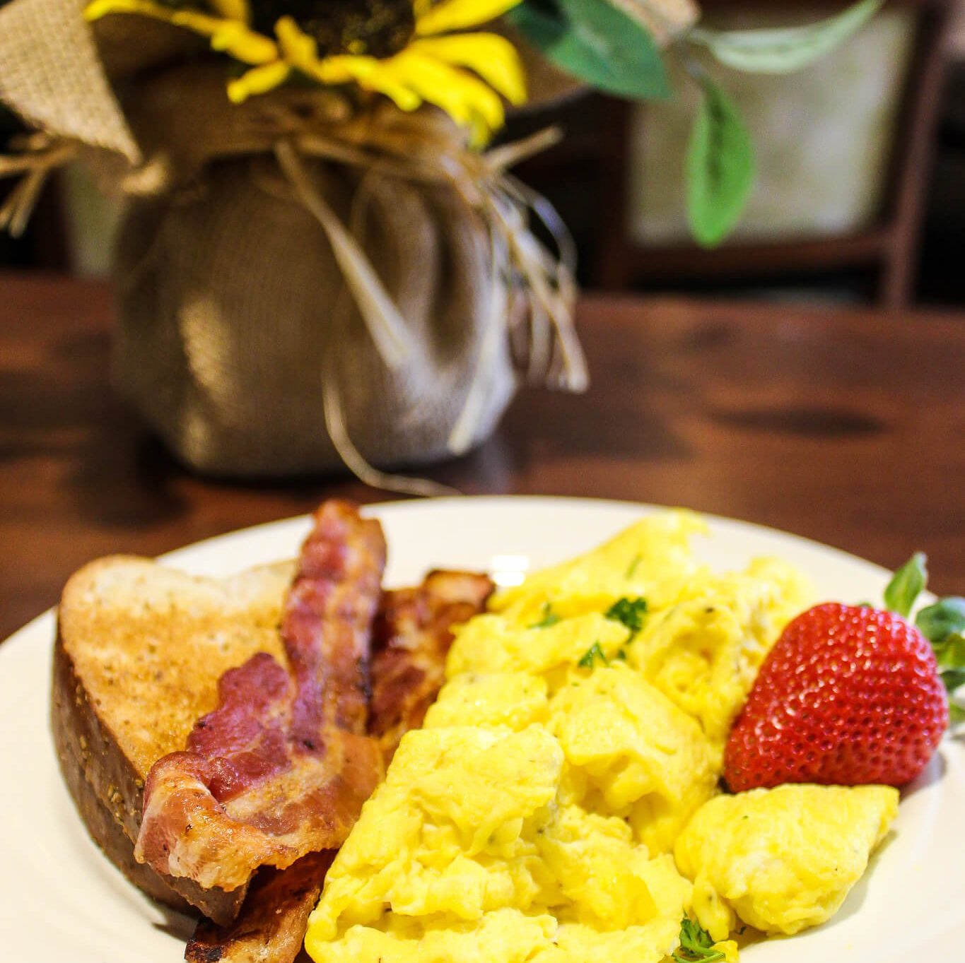 plate of bacon, scrambled eggs and toast