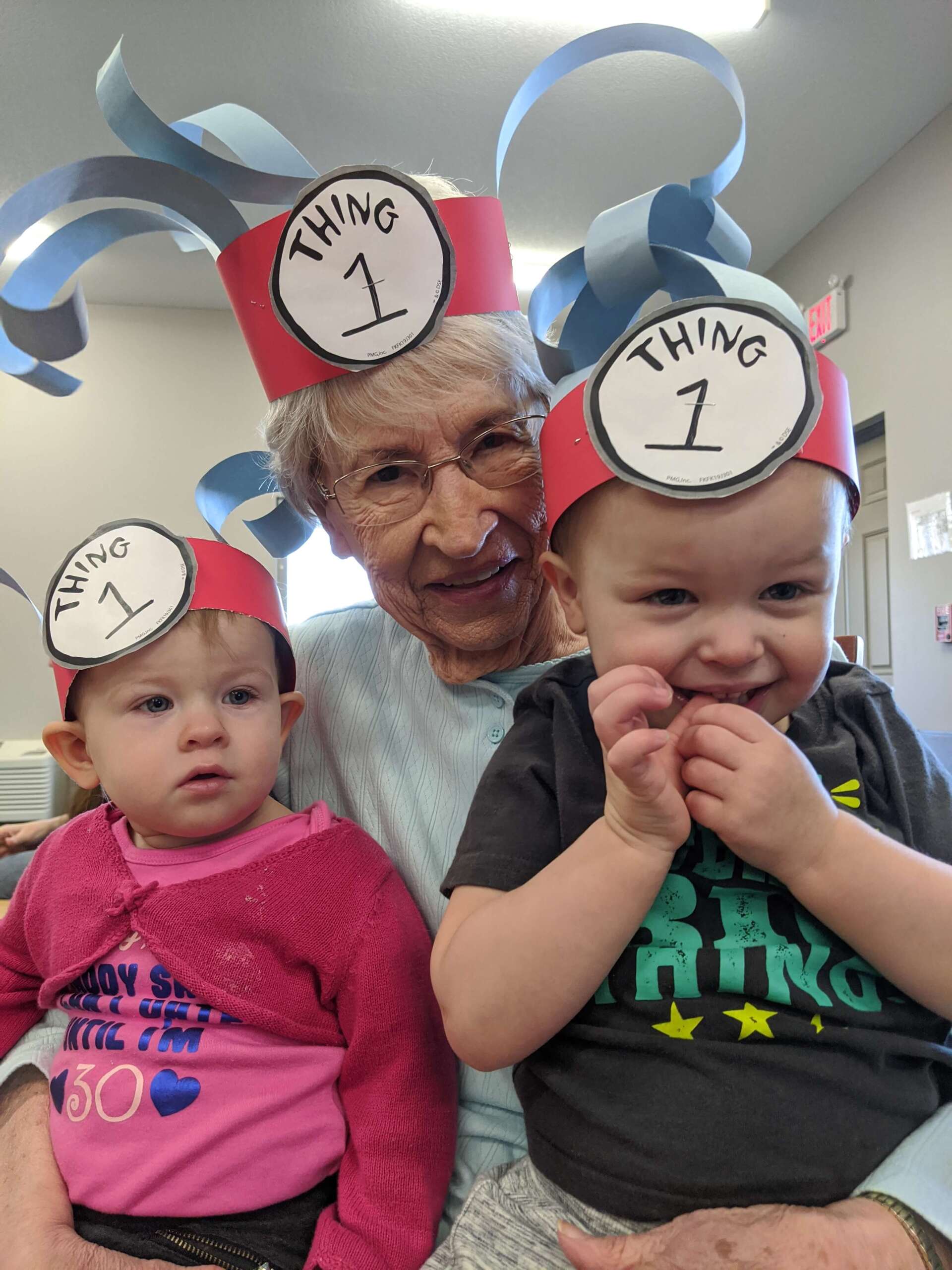 senior living resident spending time with children of It Takes a Village Childcare laughing and playing