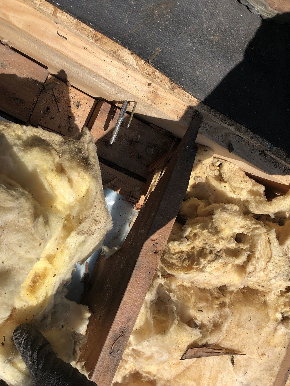 A close up of a piece of insulation on a wooden surface.