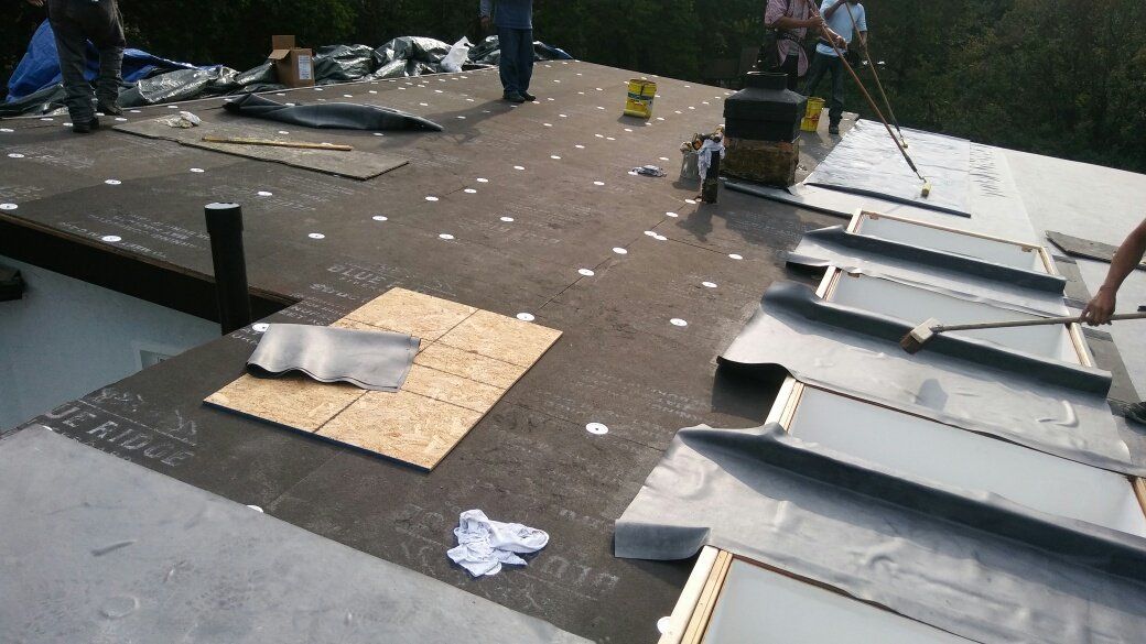 A group of people are working on a roof.