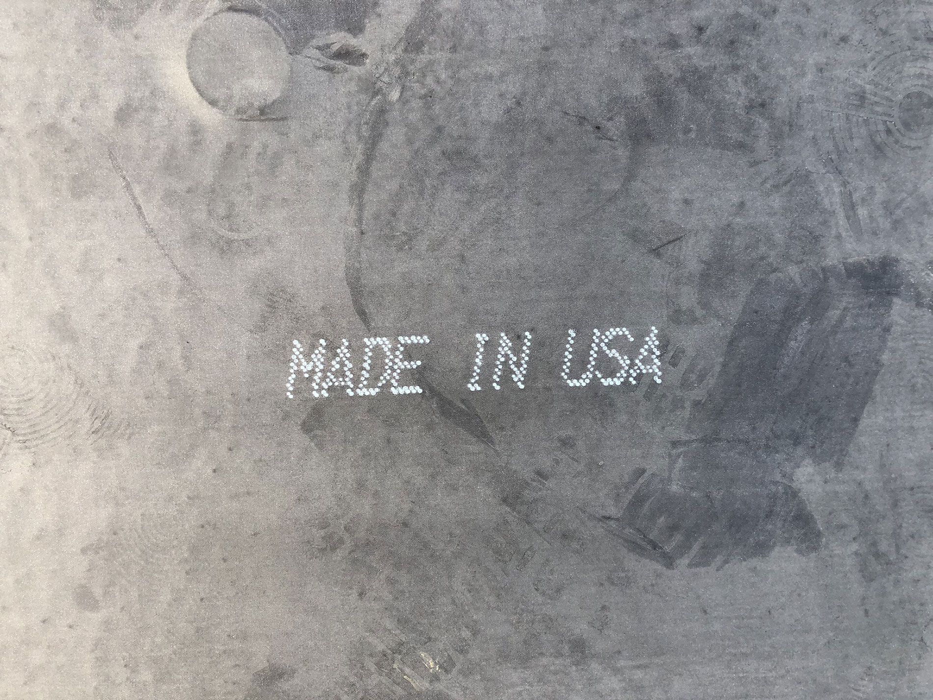 A black and white photo of a concrete surface with the words made in usa written on it.