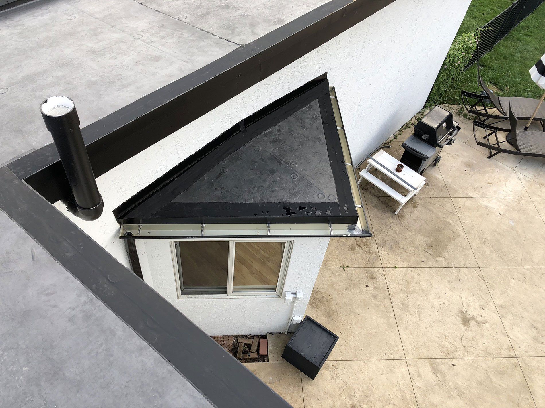 An aerial view of a house with a triangle roof