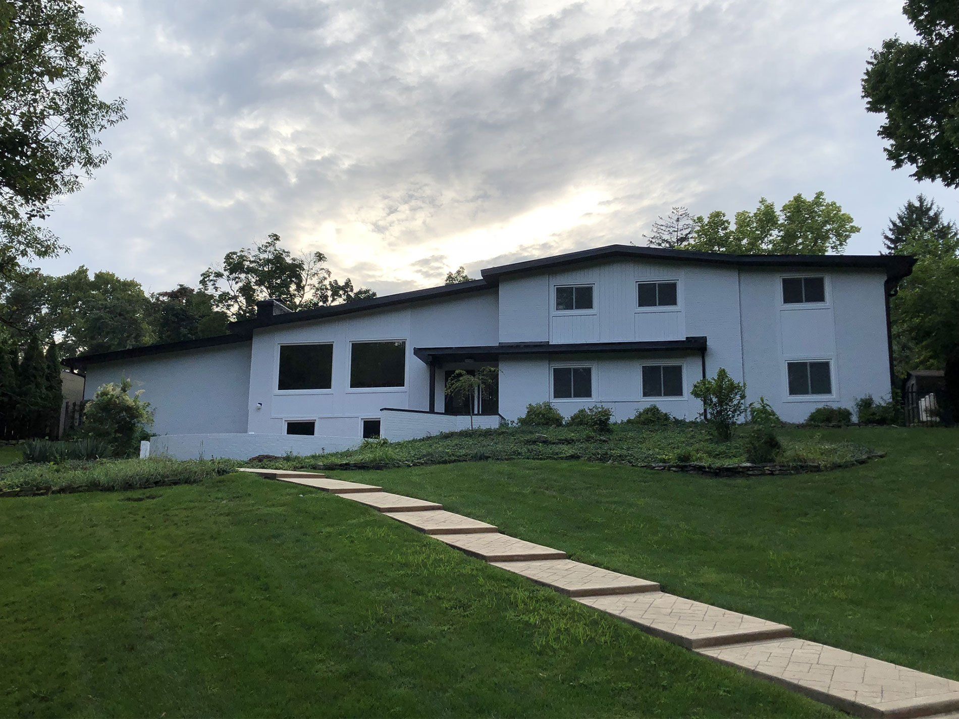 A white house with a walkway leading to it