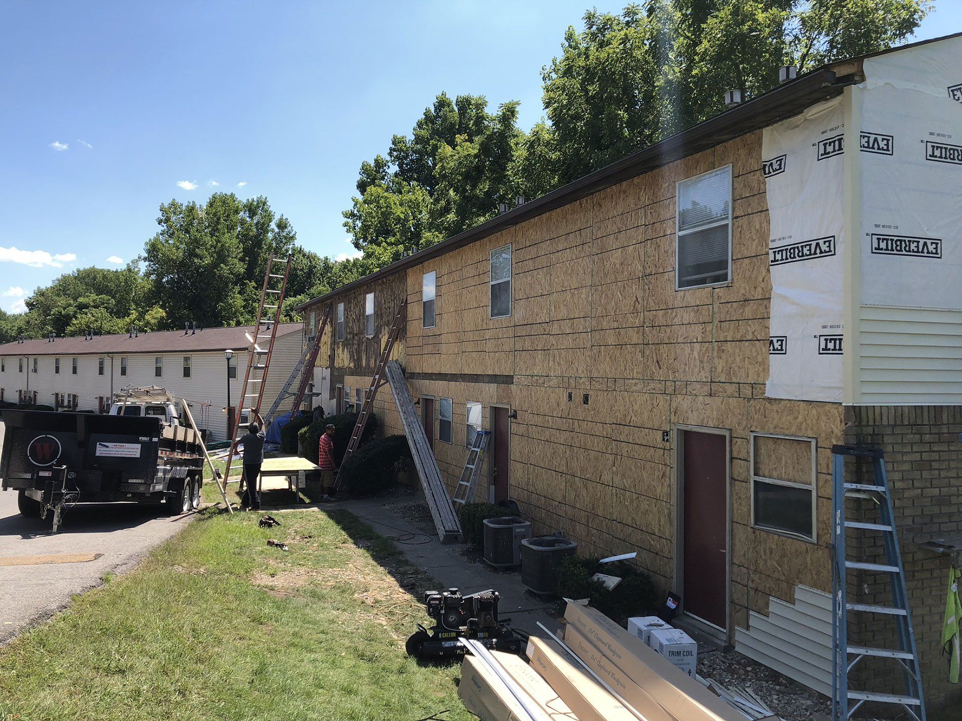 A building is being remodeled with a truck parked in front of it.