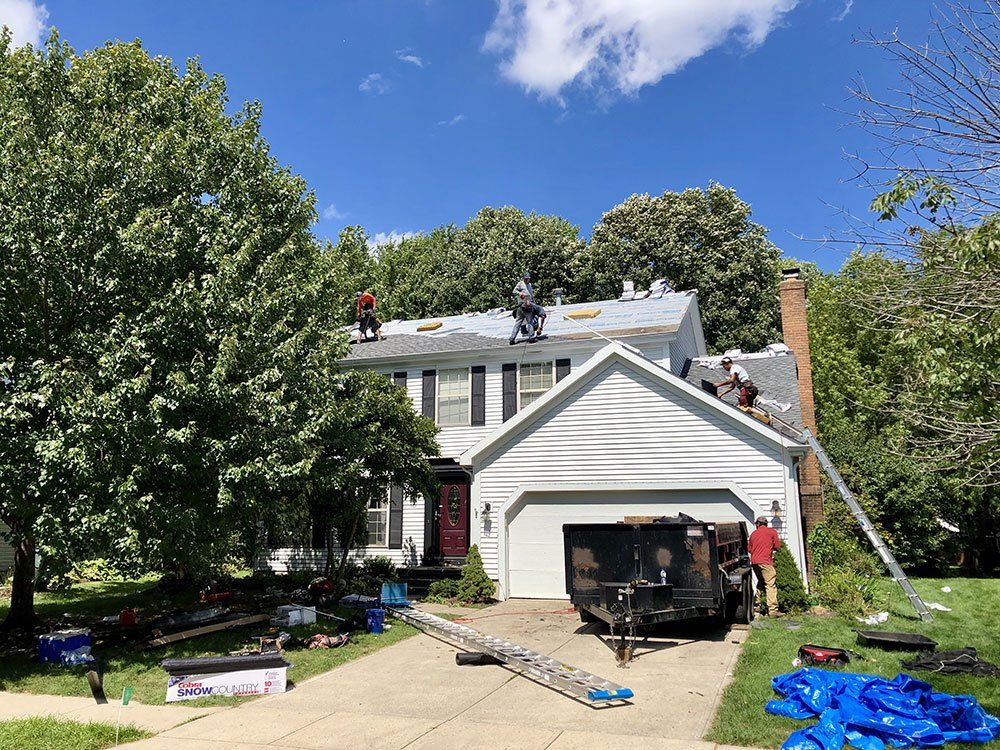 A house is being remodeled with a roof being installed.