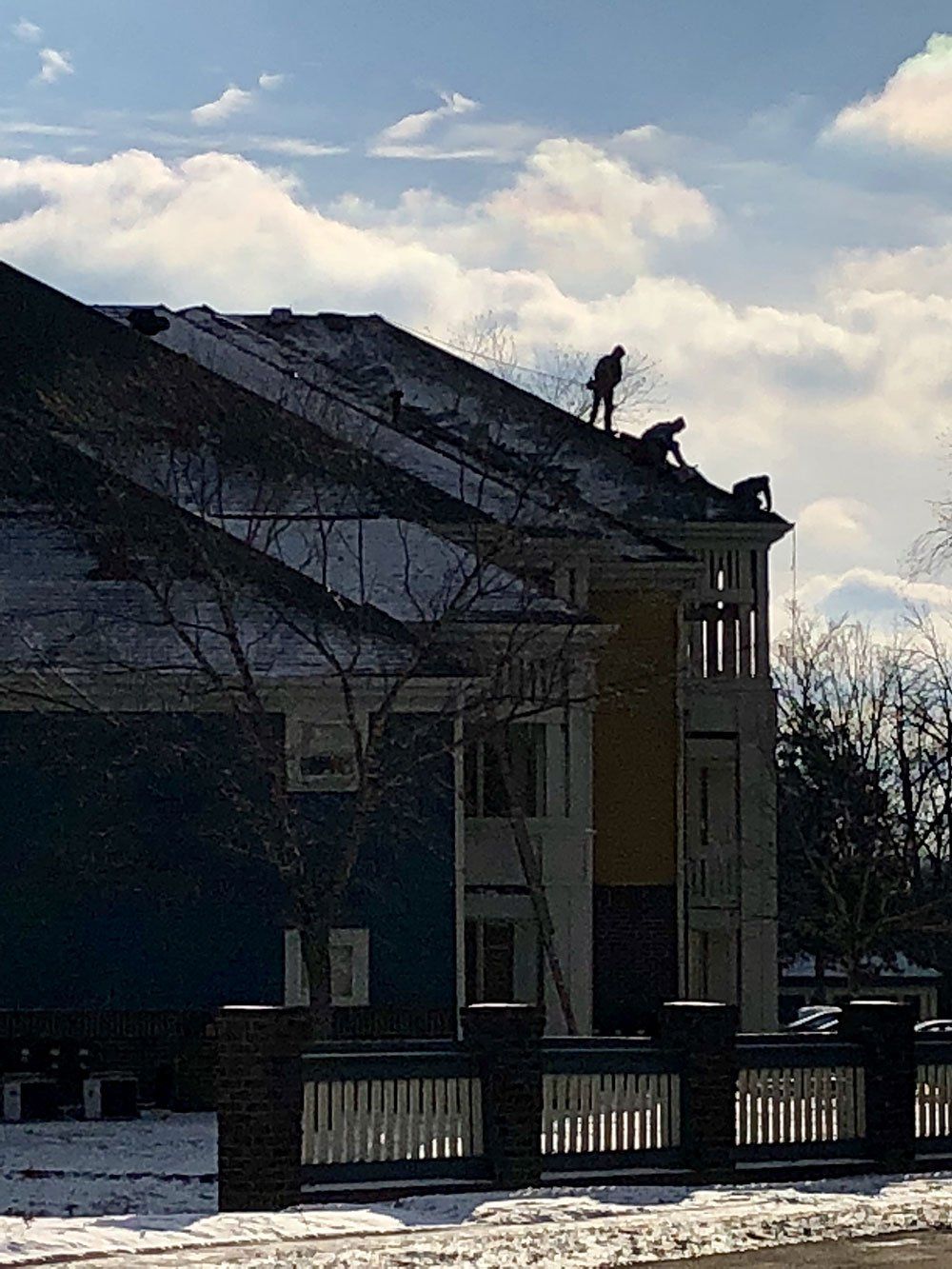 A man is working on the roof of a building.
