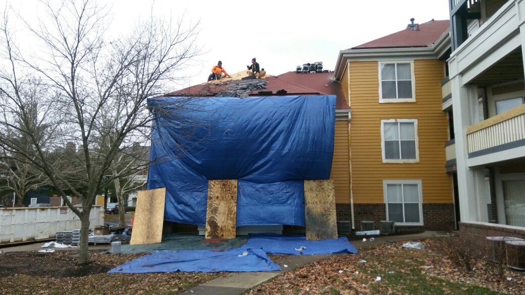 A group of people are working on the roof of a building.