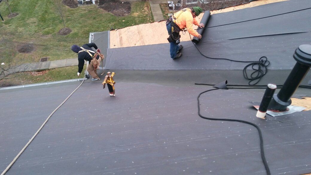 A group of people are working on a roof.