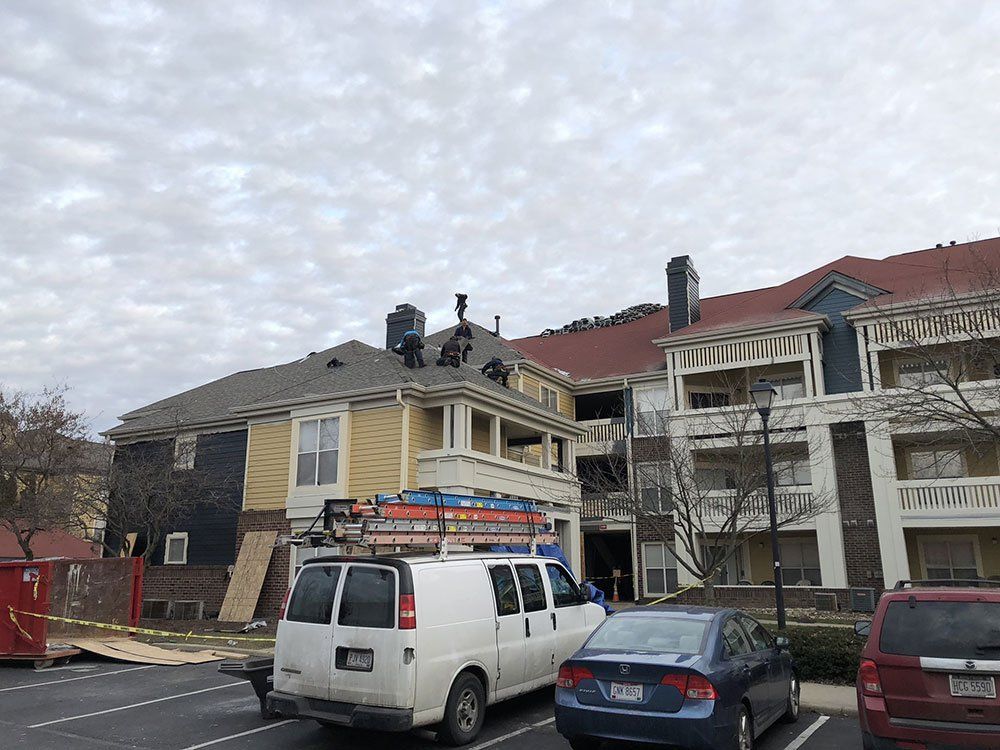 A white van is parked in front of a building.