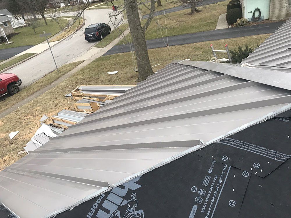 A metal roof is being installed on a house.