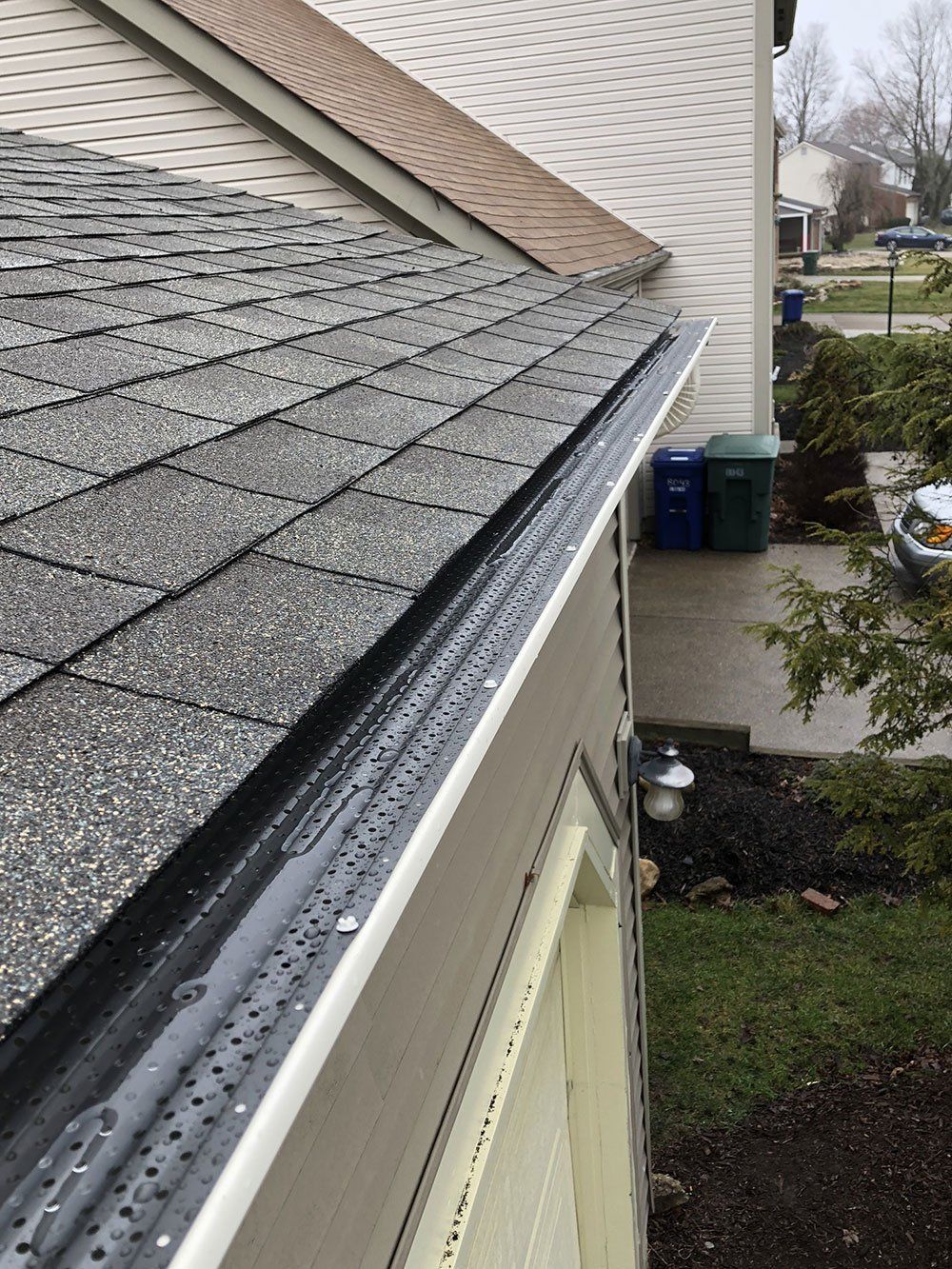 A close up of a gutter on the side of a house.