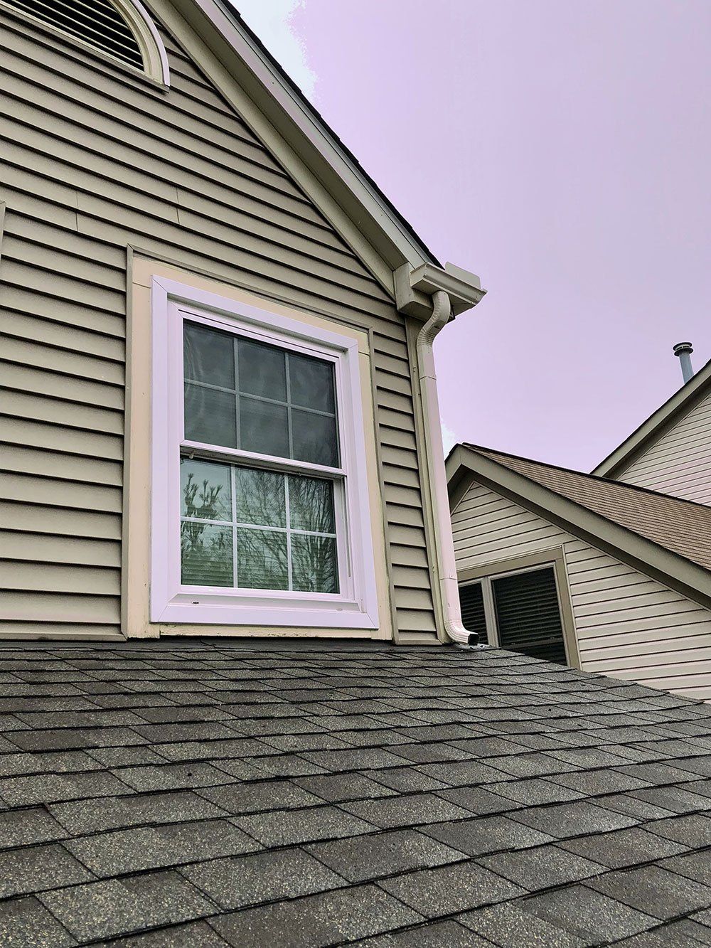 A house with a window on the side of it and a roof.