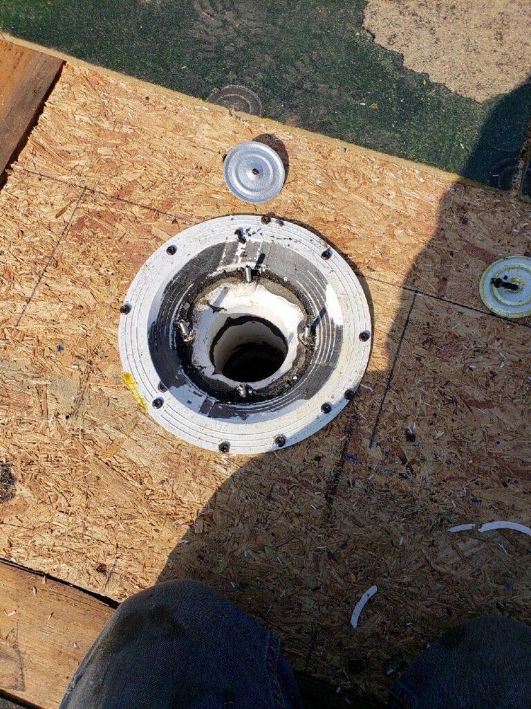 A close up of a hole in a piece of wood.