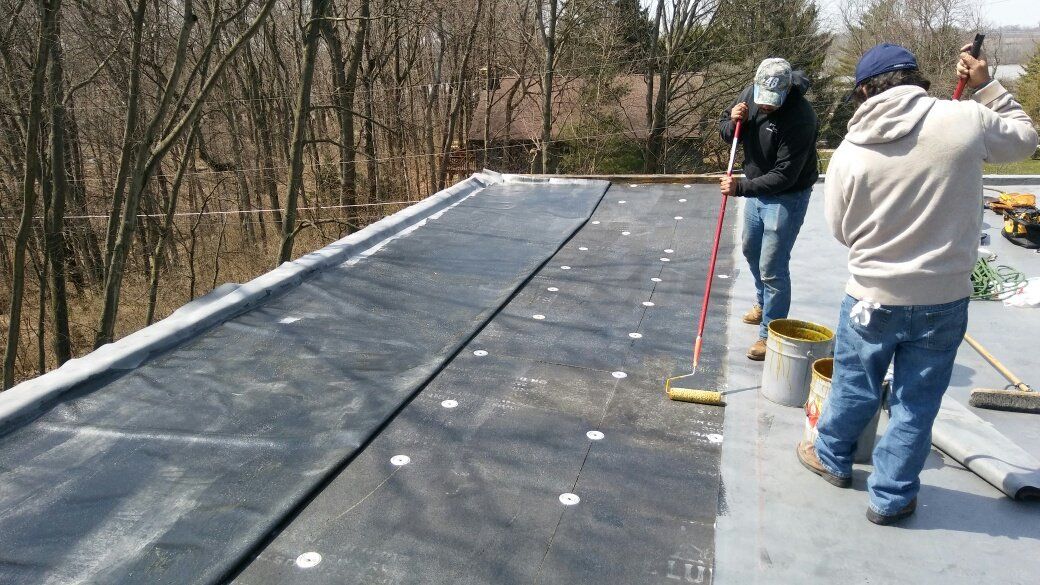 A group of men are working on a roof.