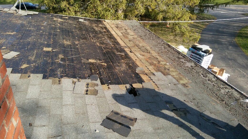 A roof with a shadow of a person on it.
