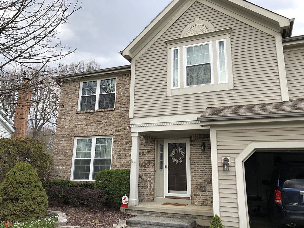 A house with a car parked in front of it