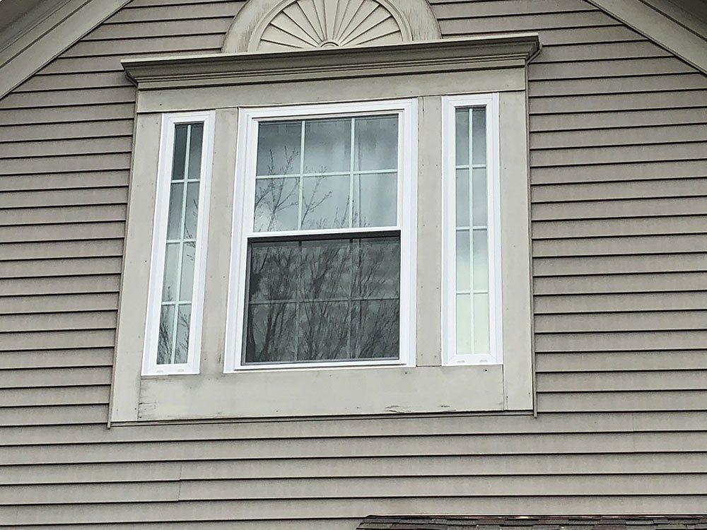 A close up of a window on the side of a house.