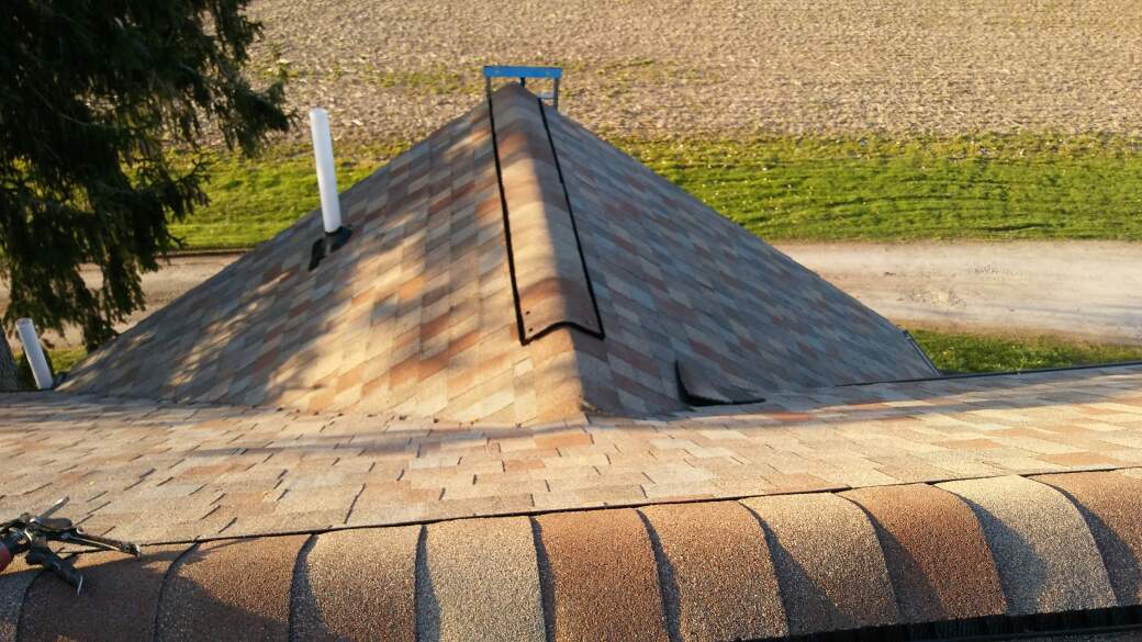 A large pile of shingles on top of a roof.