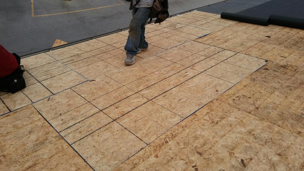 A man is standing on top of a wooden floor.