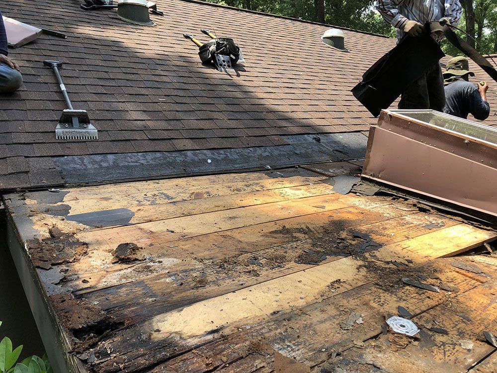 A man is working on the roof of a house.