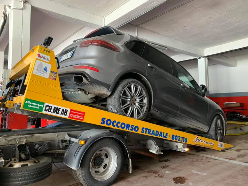 carro attrezzi con automobile su piattaforma inclinata