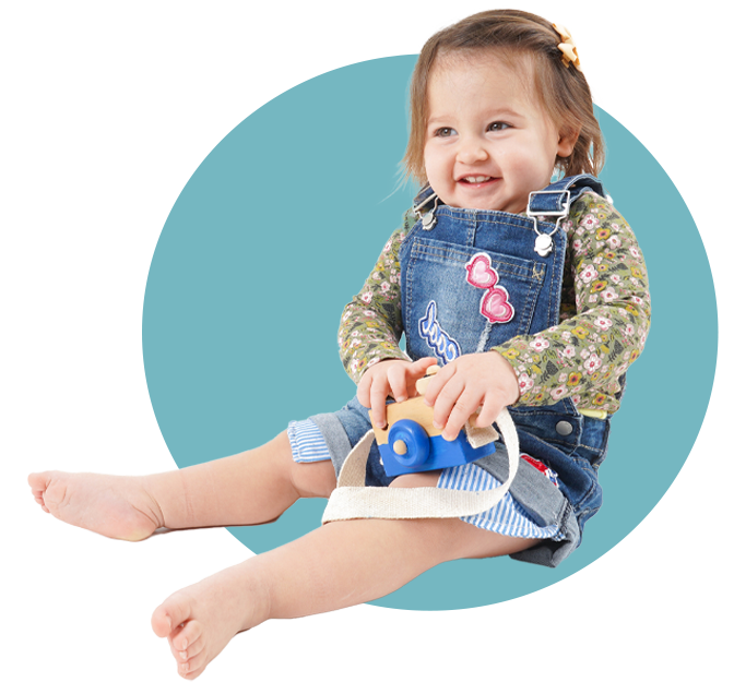 Little Girl with Camera — Holmesville, NSW — Holmesville Playhouse Preschool A little girl at a child care centre near Cameron Park