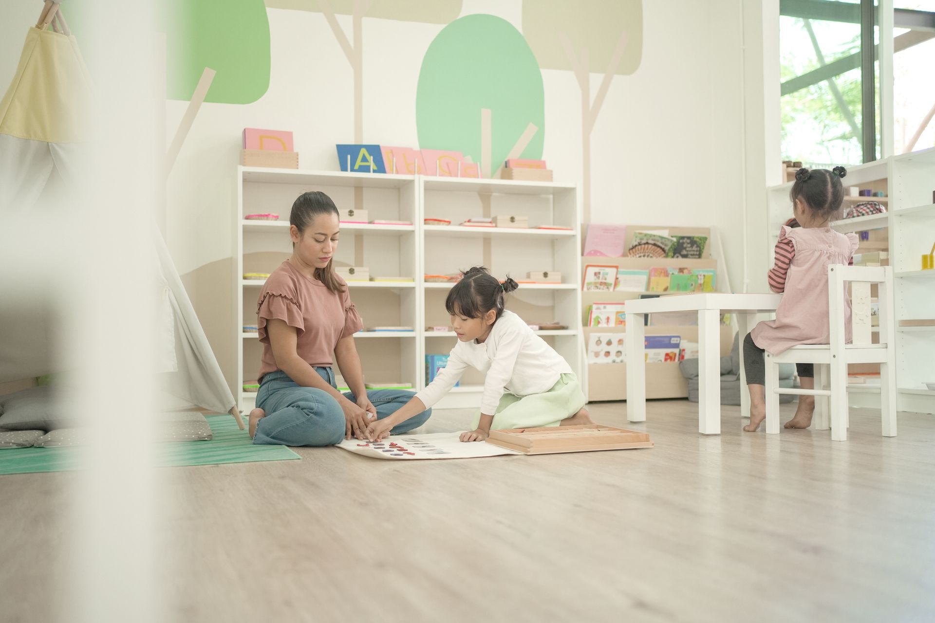 Elementary girl learning words using Moveable Alphabet.