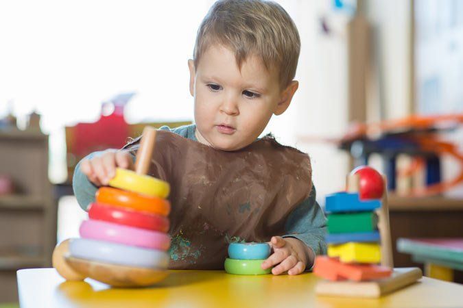Boy Playing with Montessori Toy — Holmesville, NSW — Holmesville Playhouse Preschool