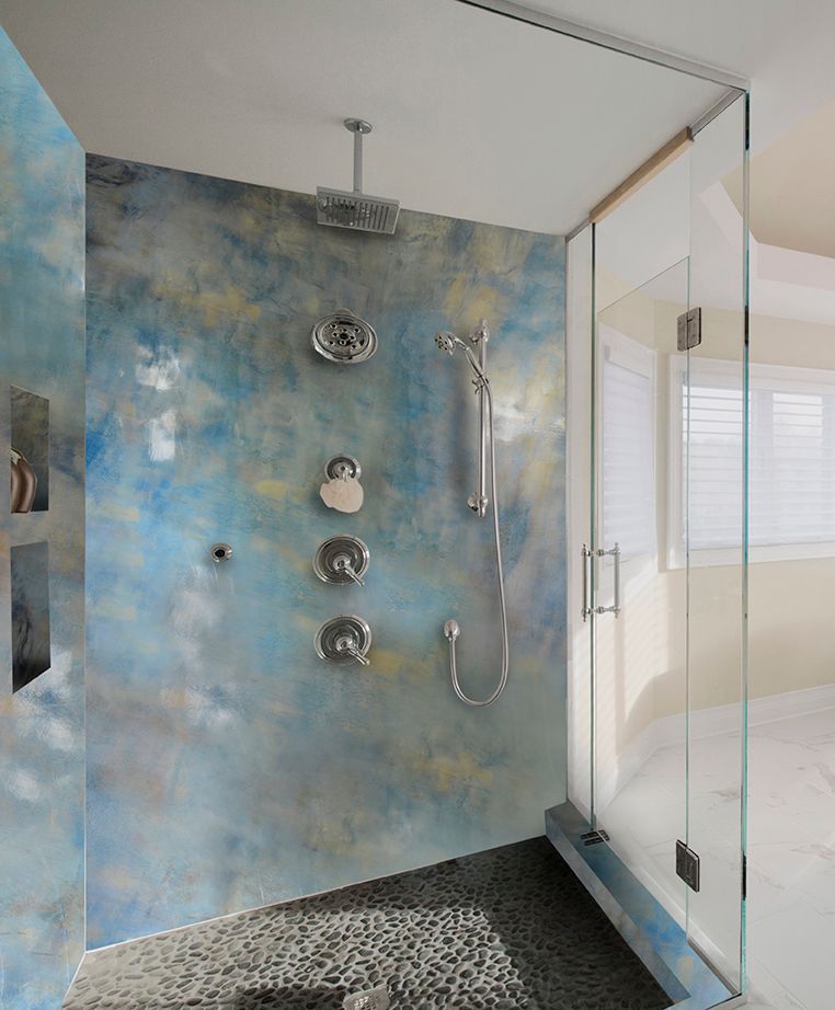 A bathroom with a walk in shower with a glass door