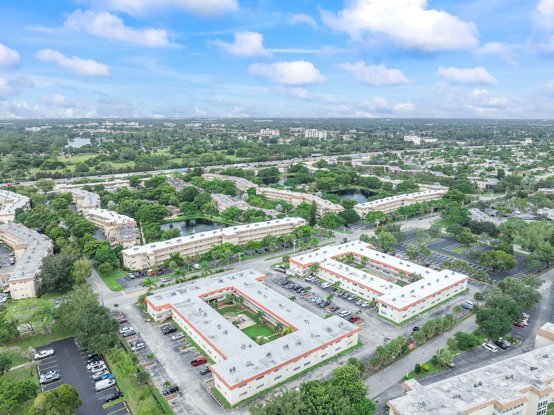 An aerial view of a residential area with lots of buildings and trees.