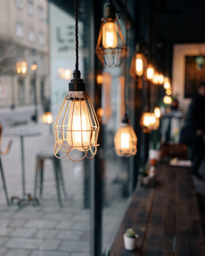 A row of light bulbs hanging from the ceiling in a restaurant
