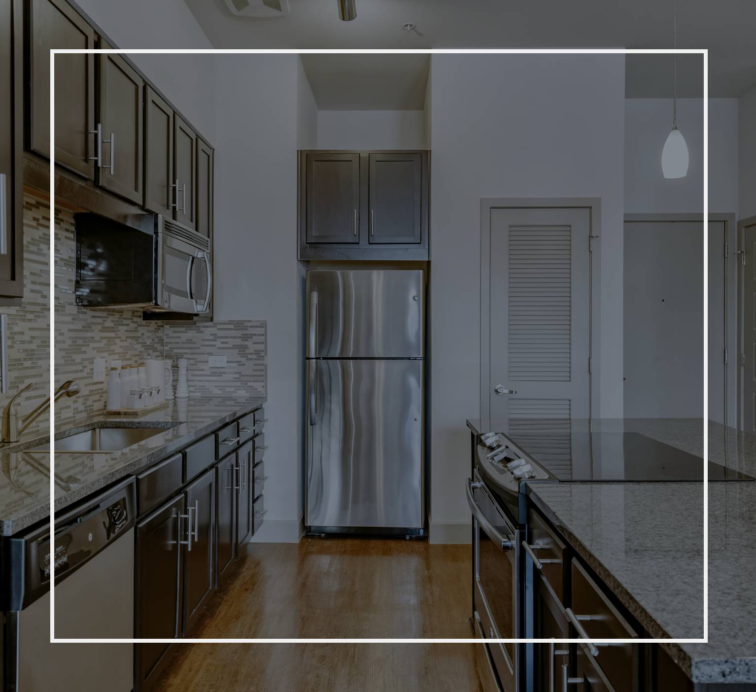 A kitchen with stainless steel appliances and granite counter tops