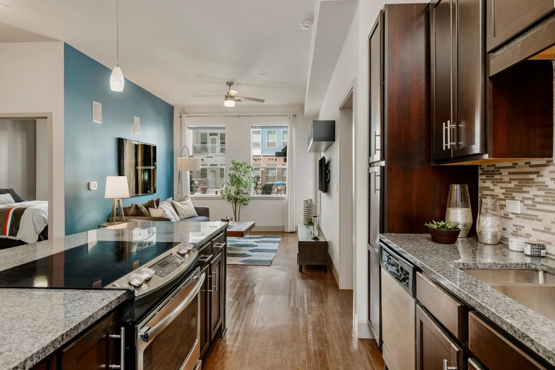 A kitchen with stainless steel appliances and granite counter tops.
