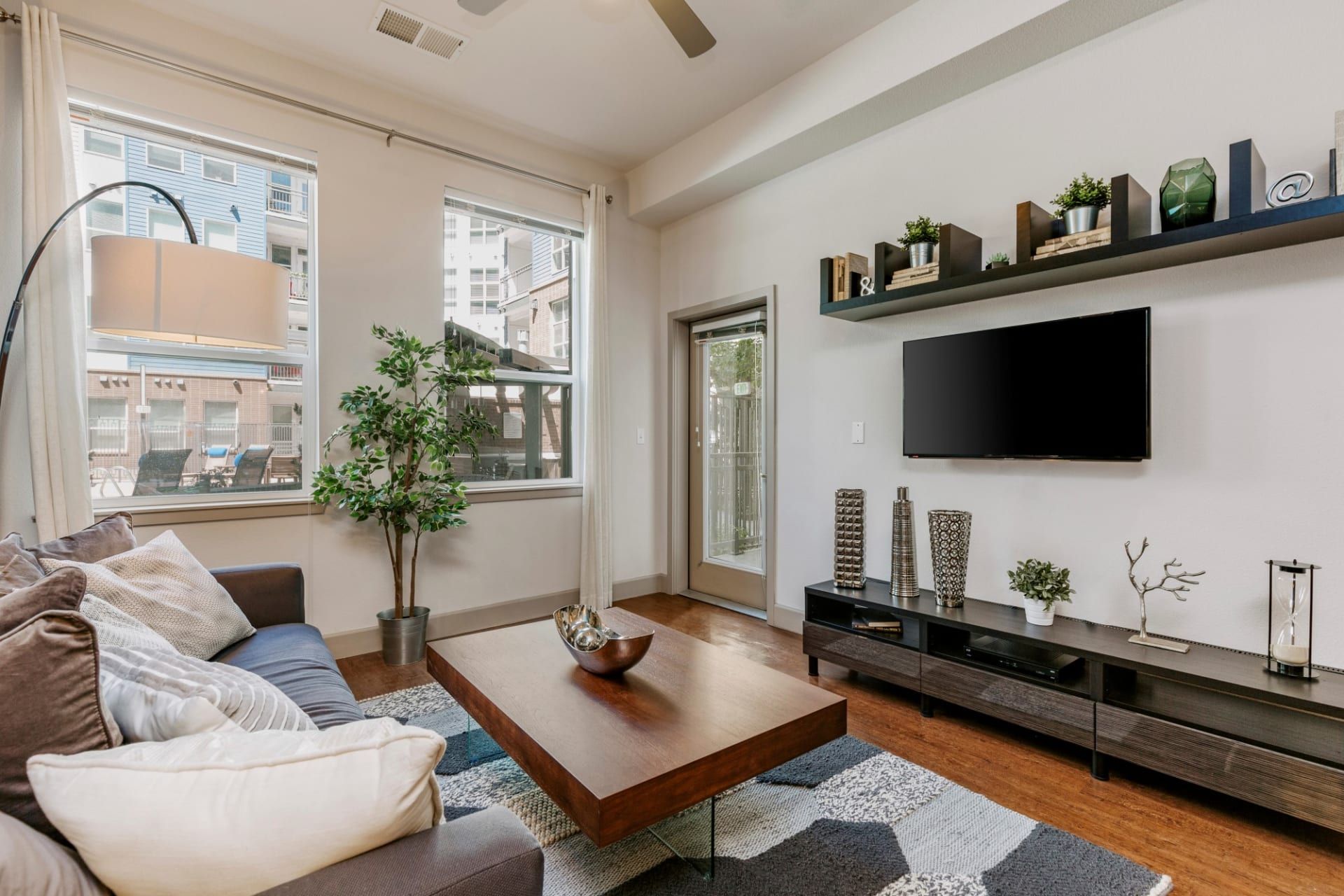 A living room with a couch , coffee table , and television.