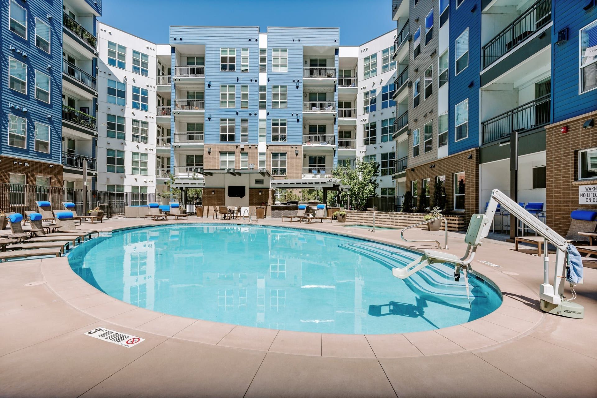 There is a large swimming pool in the middle of a building.