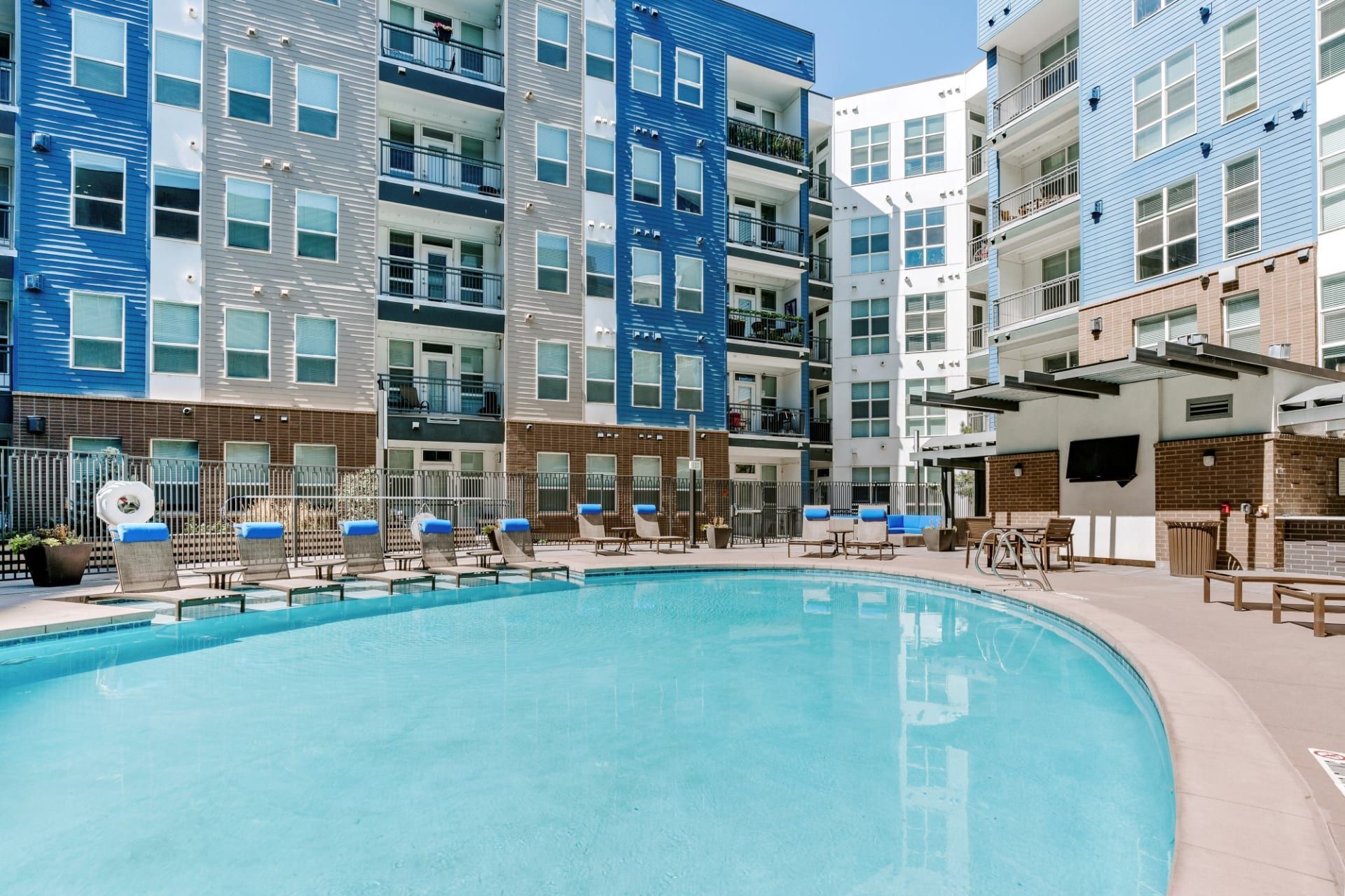 There is a large swimming pool in the middle of a building.