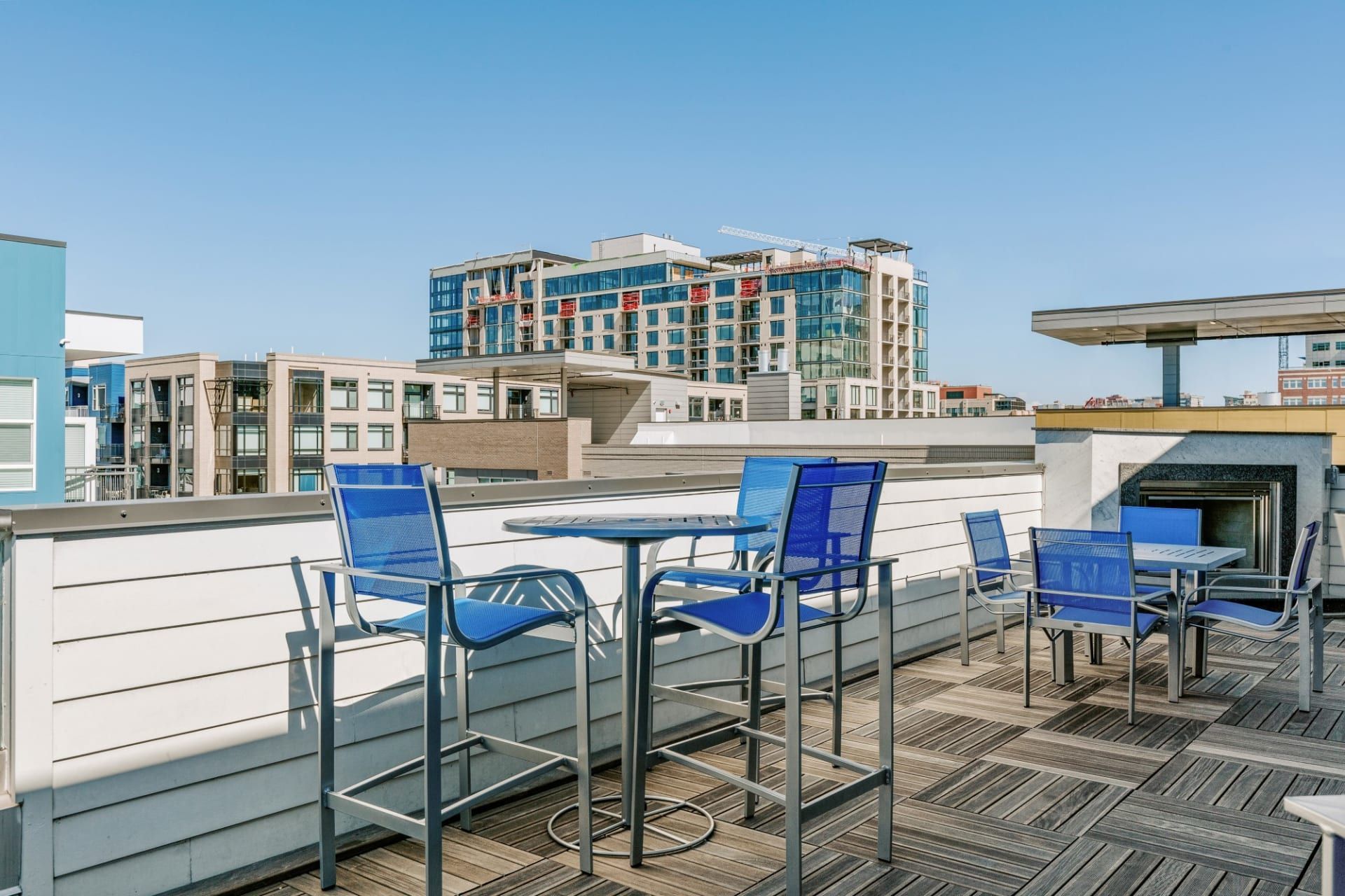 A rooftop deck with tables and chairs on it