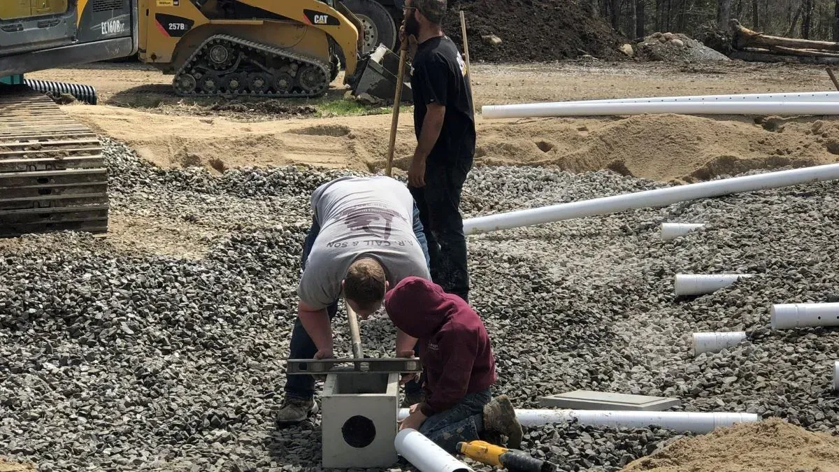 A man and a boy are working on a construction site.