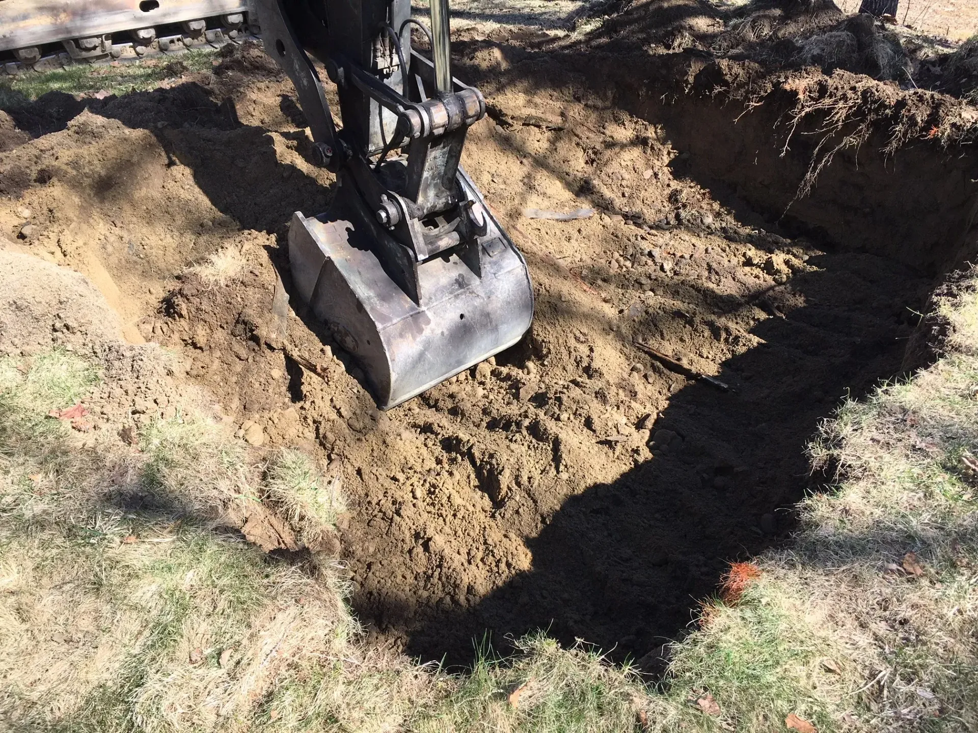 An excavator is digging a hole in the ground.
