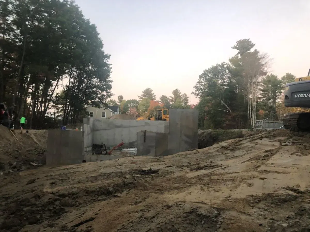 A construction site with a volvo excavator in the background.