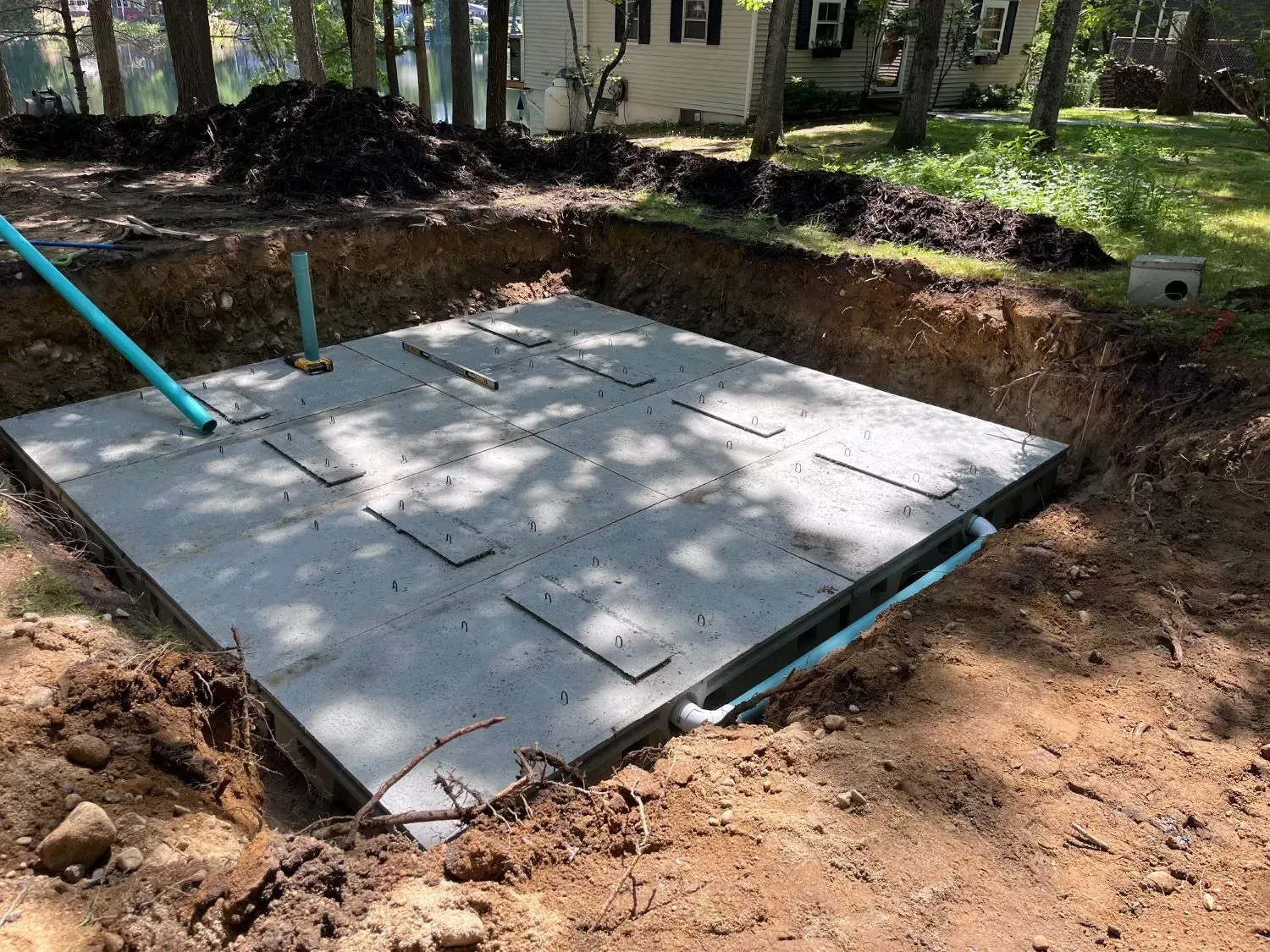 A large concrete slab is sitting in the middle of a dirt field.