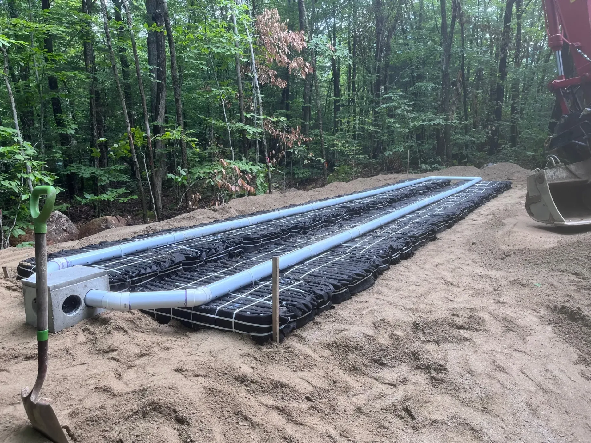 A septic system is being built in the middle of a forest.
