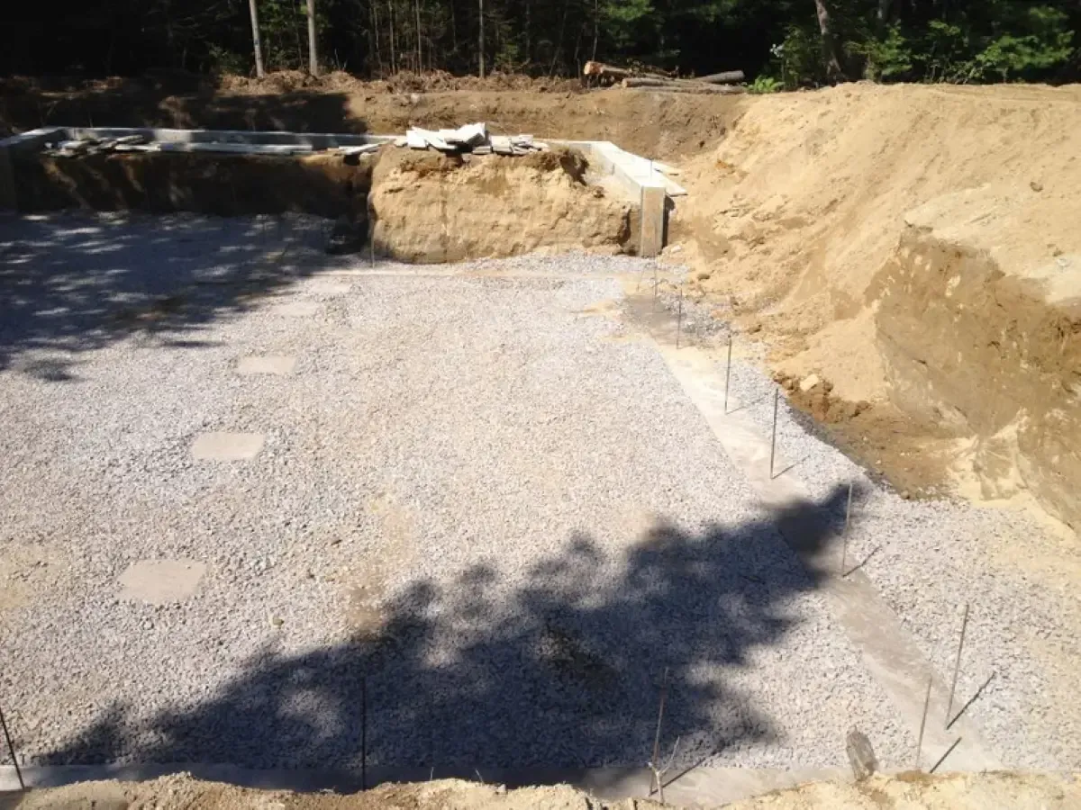A shadow of a tree is cast on a pile of gravel