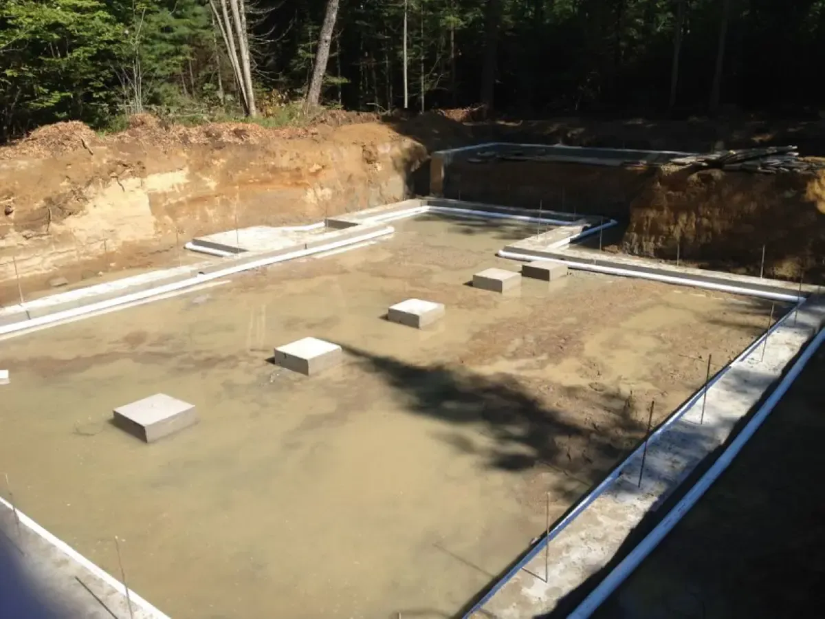 A swimming pool is being built in the middle of a forest.