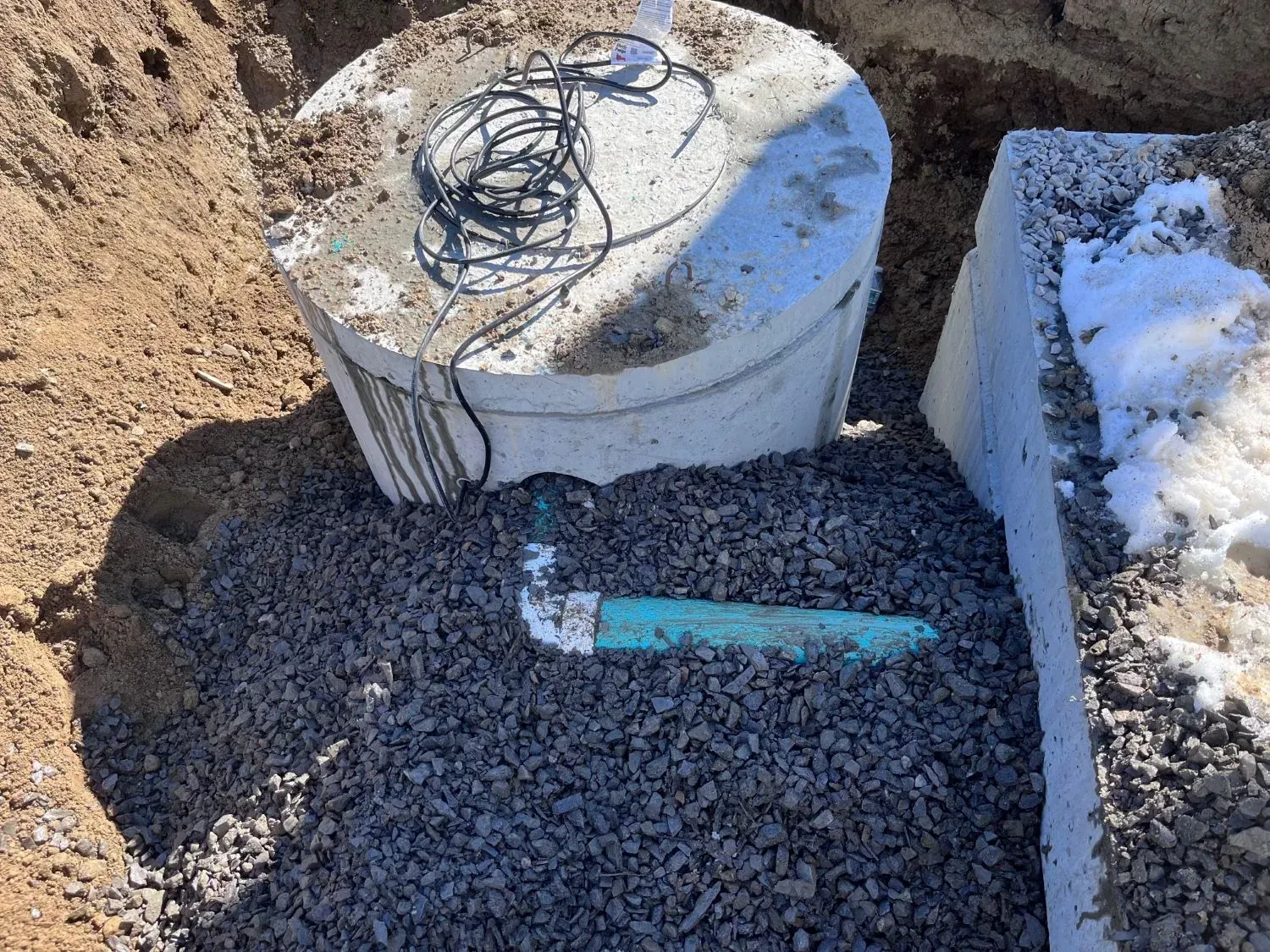 A septic tank is sitting on top of a pile of gravel.