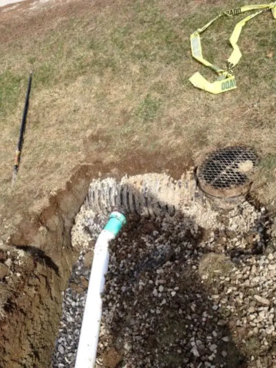 A hose is coming out of a hole in the ground.
