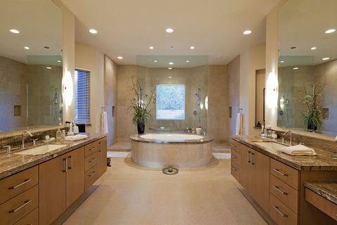 A bathroom with two sinks and a large tub